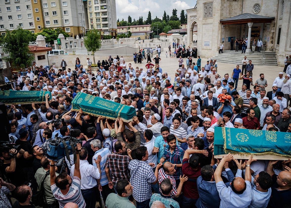 People carry the coffins of Maryam Amiri, Karime Amiri, Zahra Amiri and Huda Amiri on June 30, 2016 during their funerals two days after they were killed by a suicide bombing and gun attack targeted Istanbul's Ataturk airport, killing 42 people.