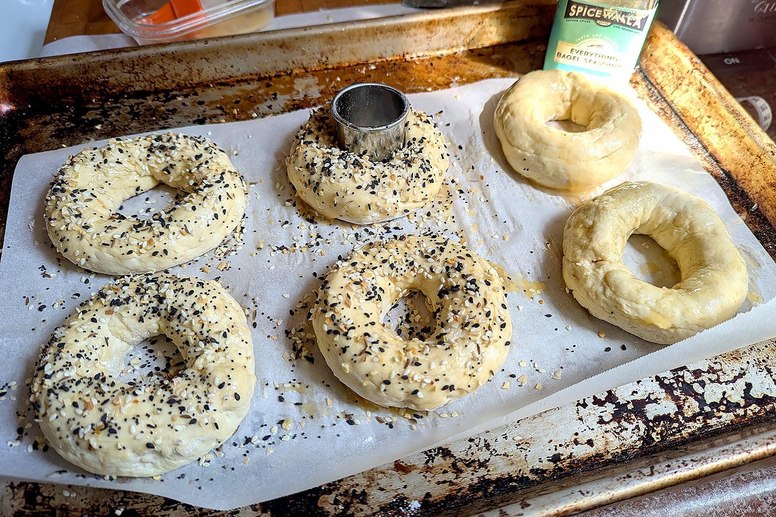 A batch of six unbaked bagels ready for the