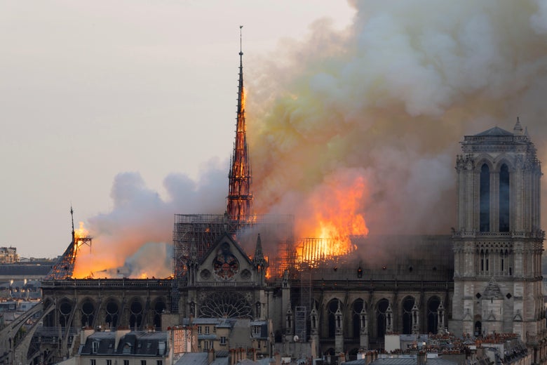 Smoke billows and flames rise from the roof of the Notre-Dame Cathedral.