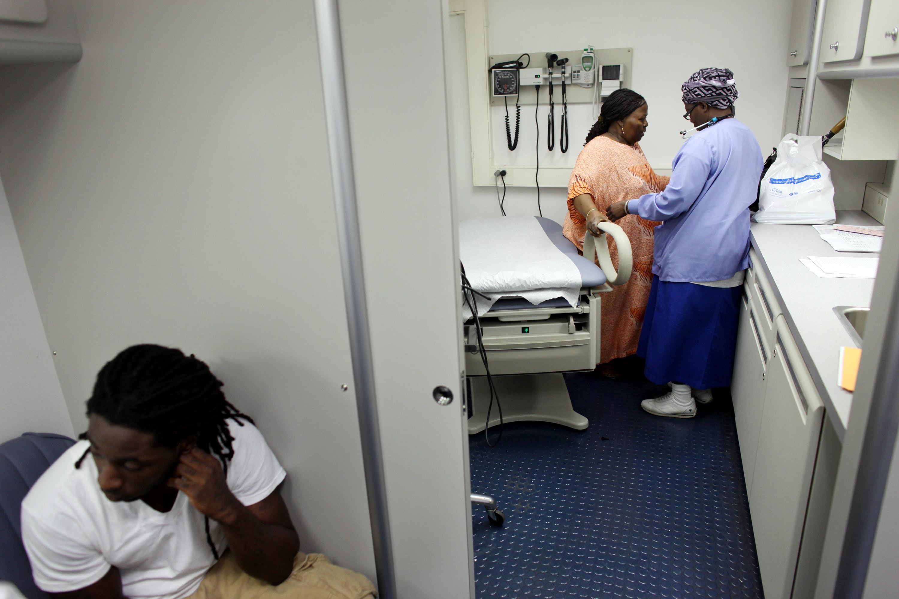 A woman is seen by a doctor.