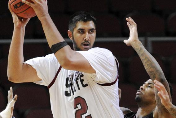 New Mexico State's Sim Bhullar looks to pass as Texas State's Joel Wright guards during the second half of a Western Athletic Conference tournament NCAA college basketball game, Friday, March 15, 2013 in Las Vegas.