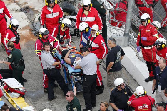 Rescue workers attend to the injured in the stands following a last-lap incident.