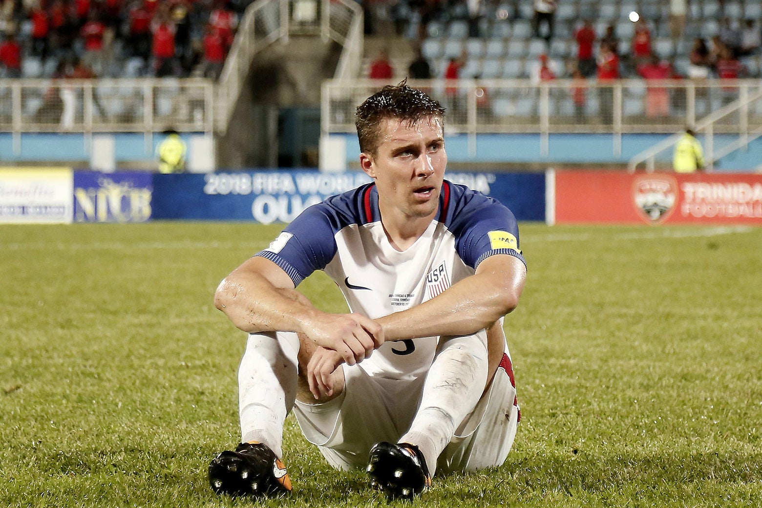 USA's Matt Besler sits on the field in dejection after losing to Trinidad and Tobago 2–1 in a qualifier match on Oct. 10.