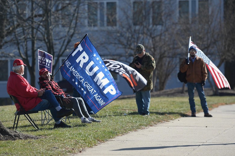 Pro-Trump protestors sitting in folding chairs.