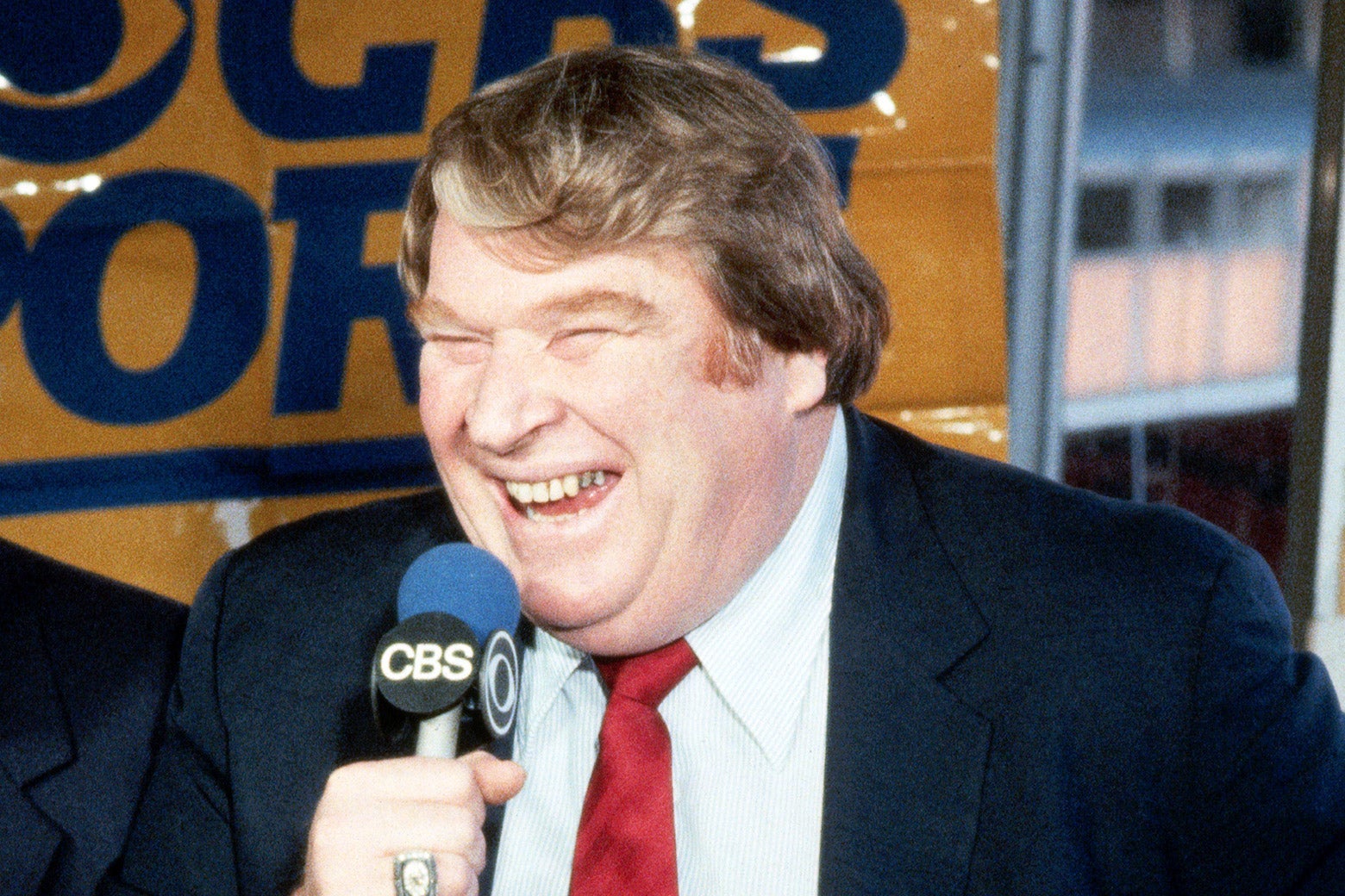 A jolly John Madden with a CBS microphone in hand.