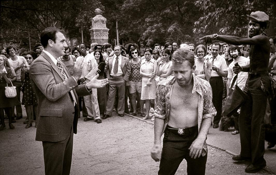 Evangelical Christians interrupted by street people, Central Park, 1974.