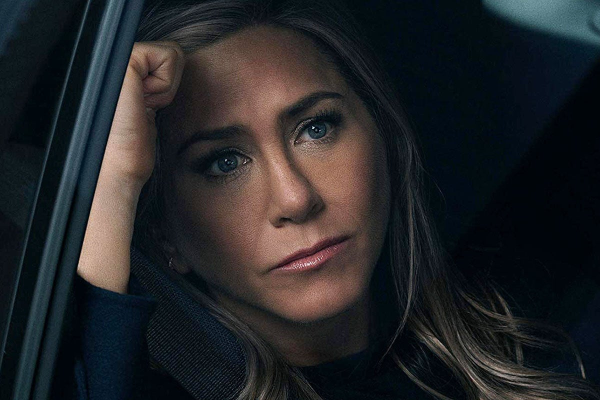 Jennifer Aniston leans against a car window, looking forlorn, in The Morning Show.