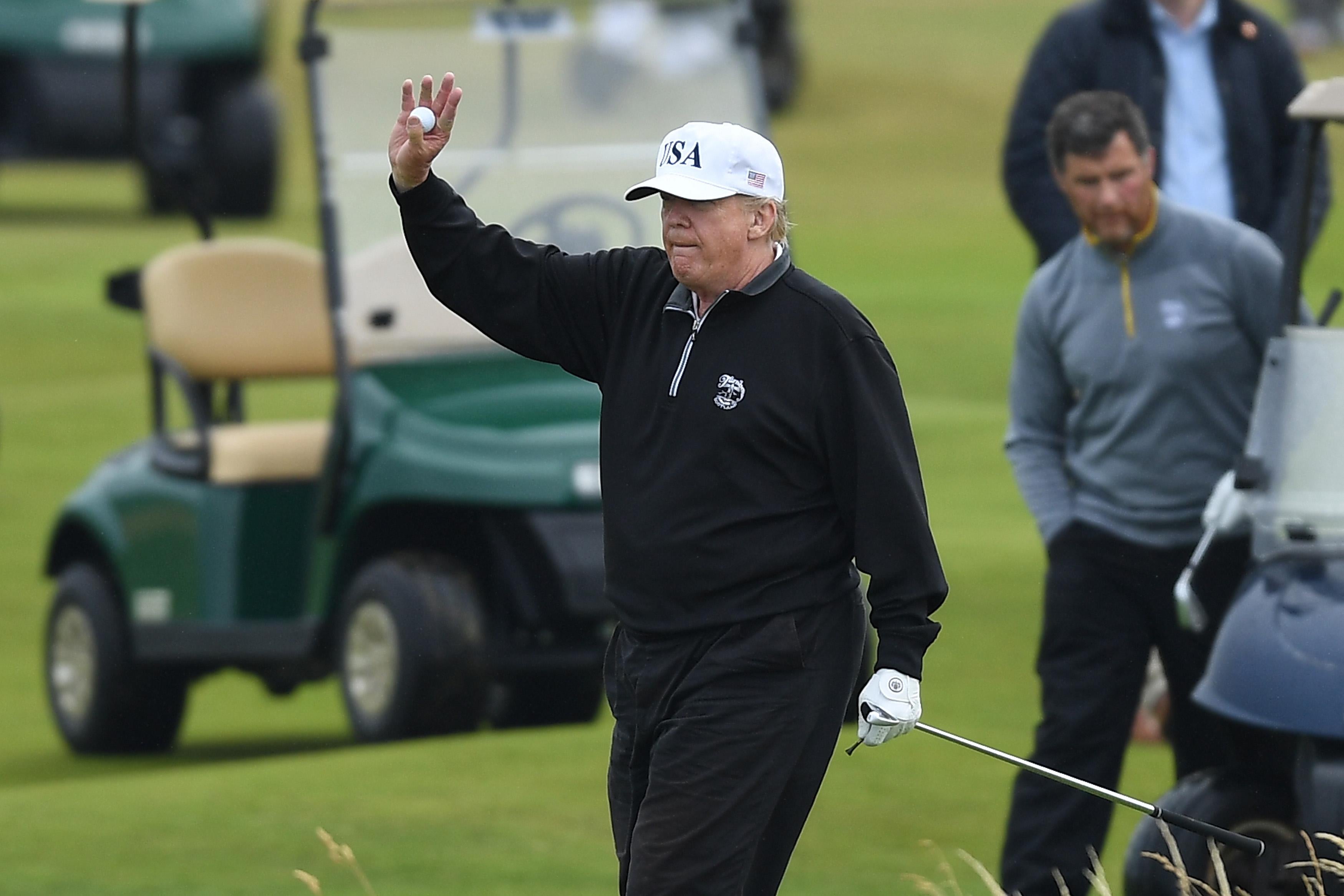 President Donald Trump waves while playing a round of golf at Trump Turnberry Luxury Collection Resort on July 15, 2018 in Turnberry, Scotland. 