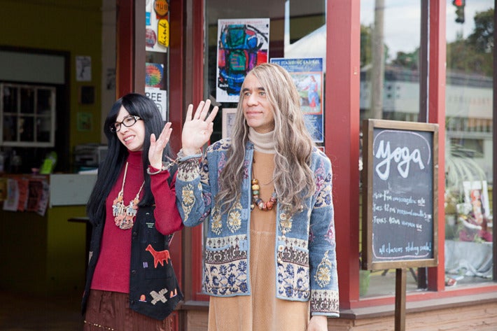 Armisen and Brownstein, in character as co-owners of the Women and Women First bookstore, blandly wave to someone off-camera. They were stereotypical, dowdy "feminist" outfits--baggy dresses, long hair, folk art-esque jewelry.