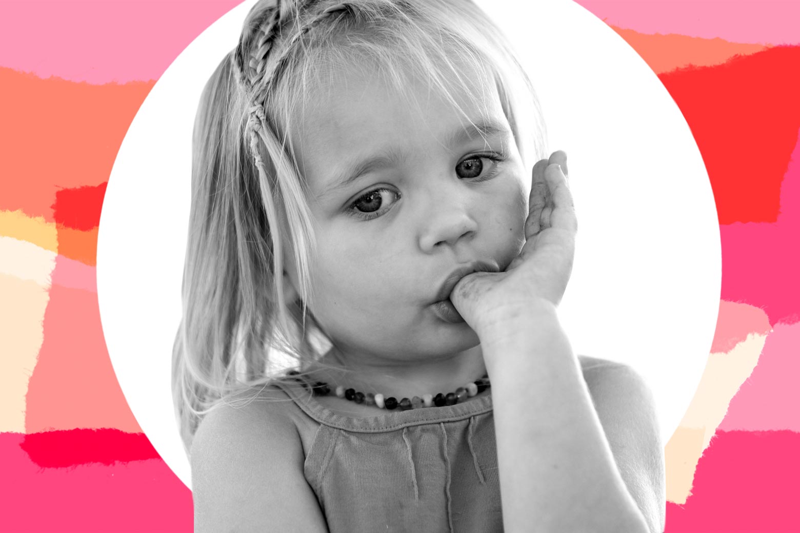 Close-up of a girl with a braid sucking her thumb.