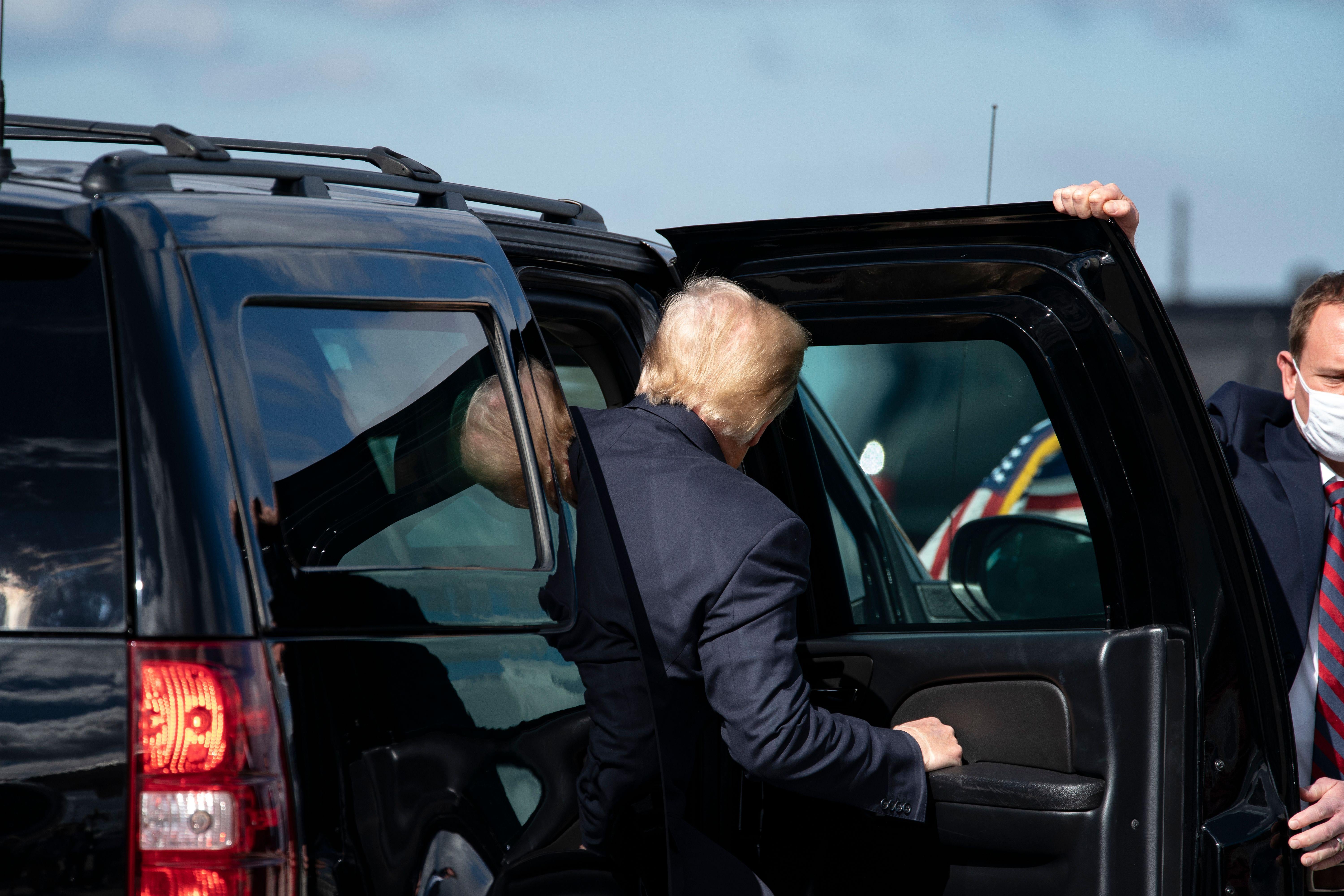 The back of Trump's head as he enters the car.