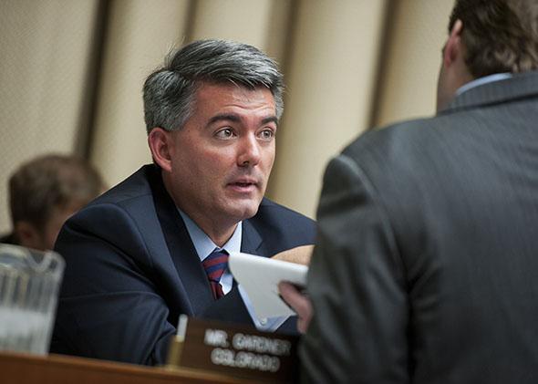 Rep. Cory Gardner, R-Colo., talks with an aide during a House Energy and Commerce Oversight and Investigations Subcommittee.