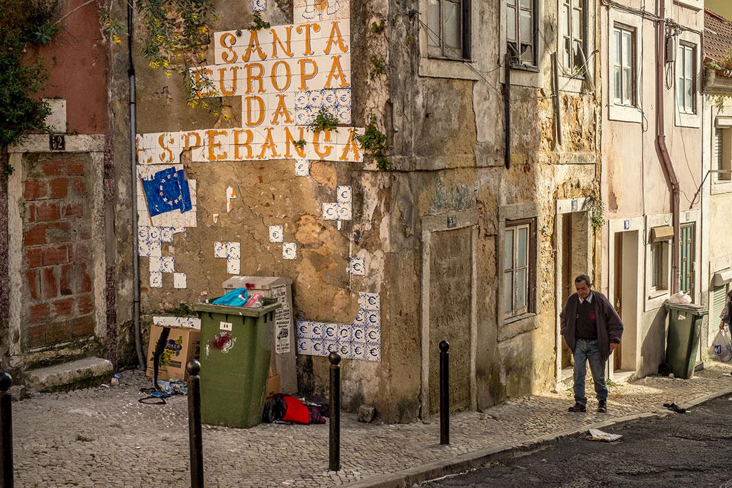 A tile painting in Lisbon, Portugal, in 2013 says “Holy Europe of Hope” with euro symbols.