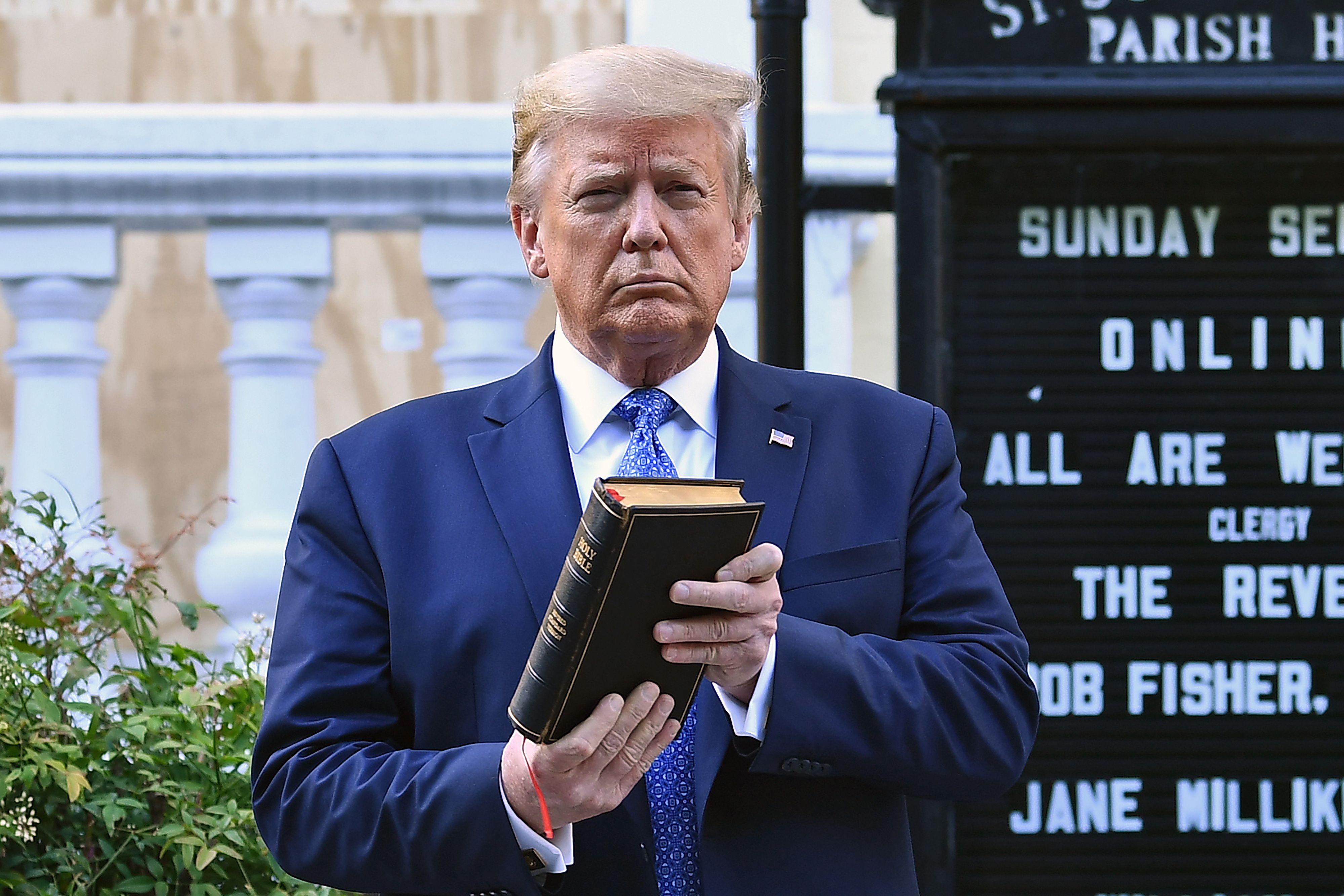 Trump holds up a Bible outside of St John's Episcopal church.
