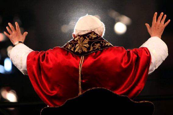 Pope Benedict XVI waves to the faithful gathered at the Colosseum.
