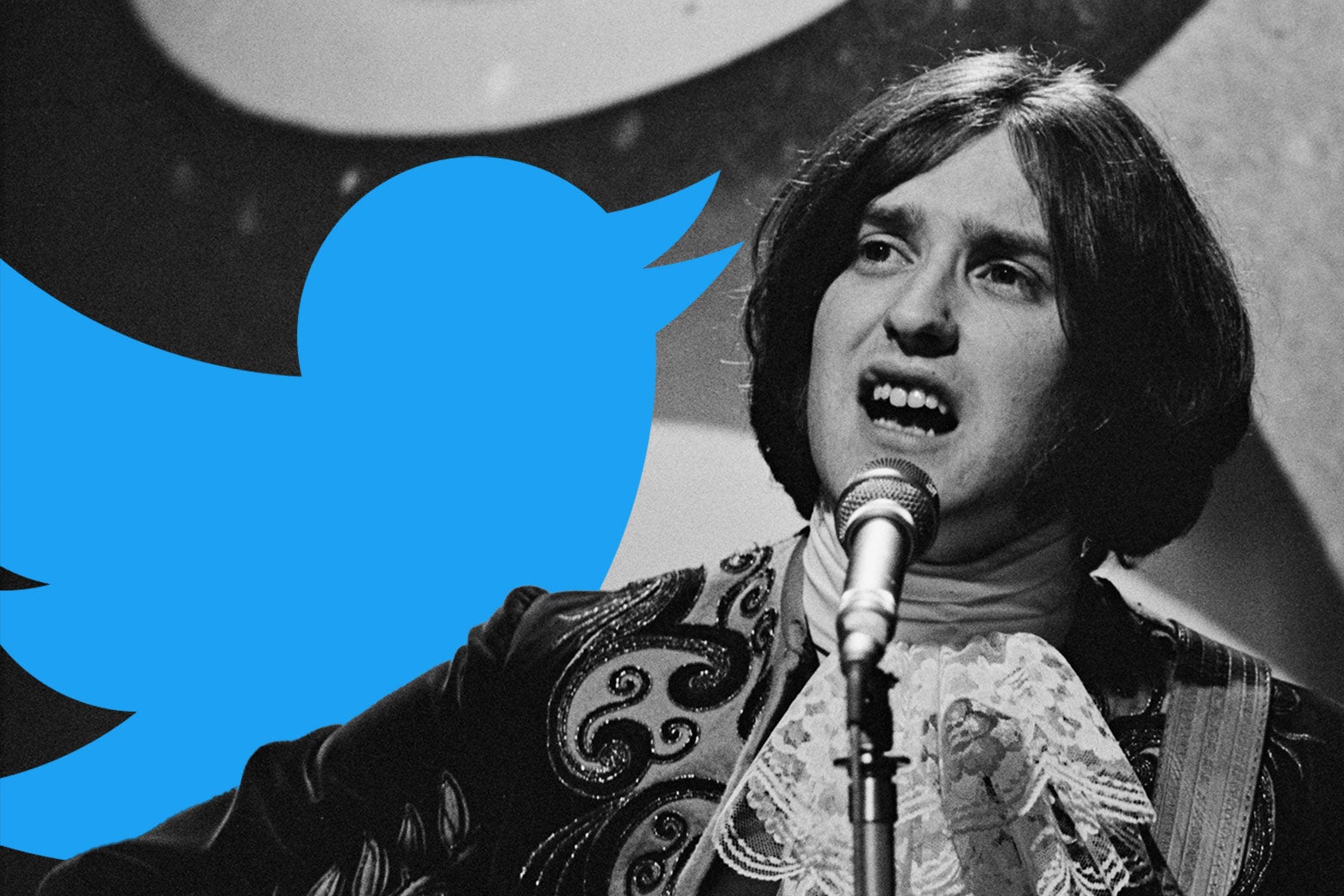 Dave Davies singing into a microphone next to a Twitter bird.