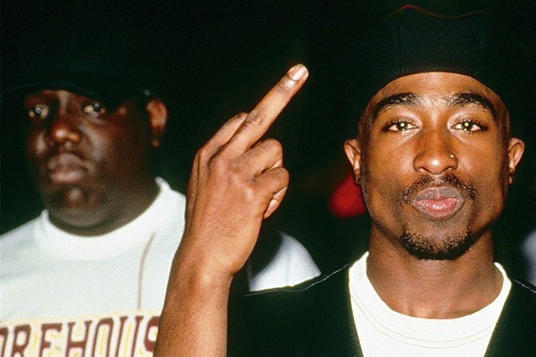The Notorious B.I.G. and Tupac Shakur backstage at Club Amazon on July 23, 1993, in New York. Tupac is flashing a crude hand gesture at the camera.