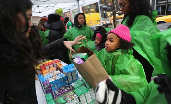 Girl Scouts brave the winter weather to sell cookies in Midtown New York City on Feb. 8, 2013, National Girl Scout Cookie Day.