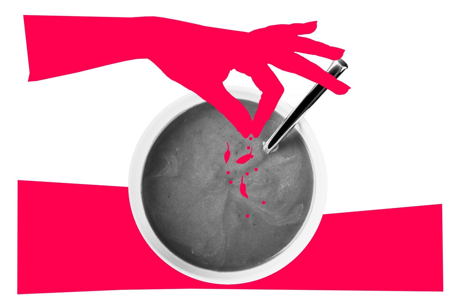 Bowl of tomato soup with a shadowed hand adding spices. 