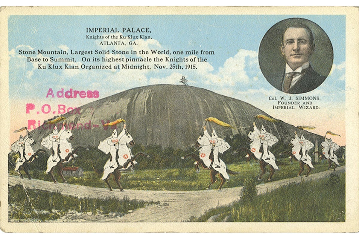 A KKK postcard depicting Klansmen riding in front of Stone Mountain.