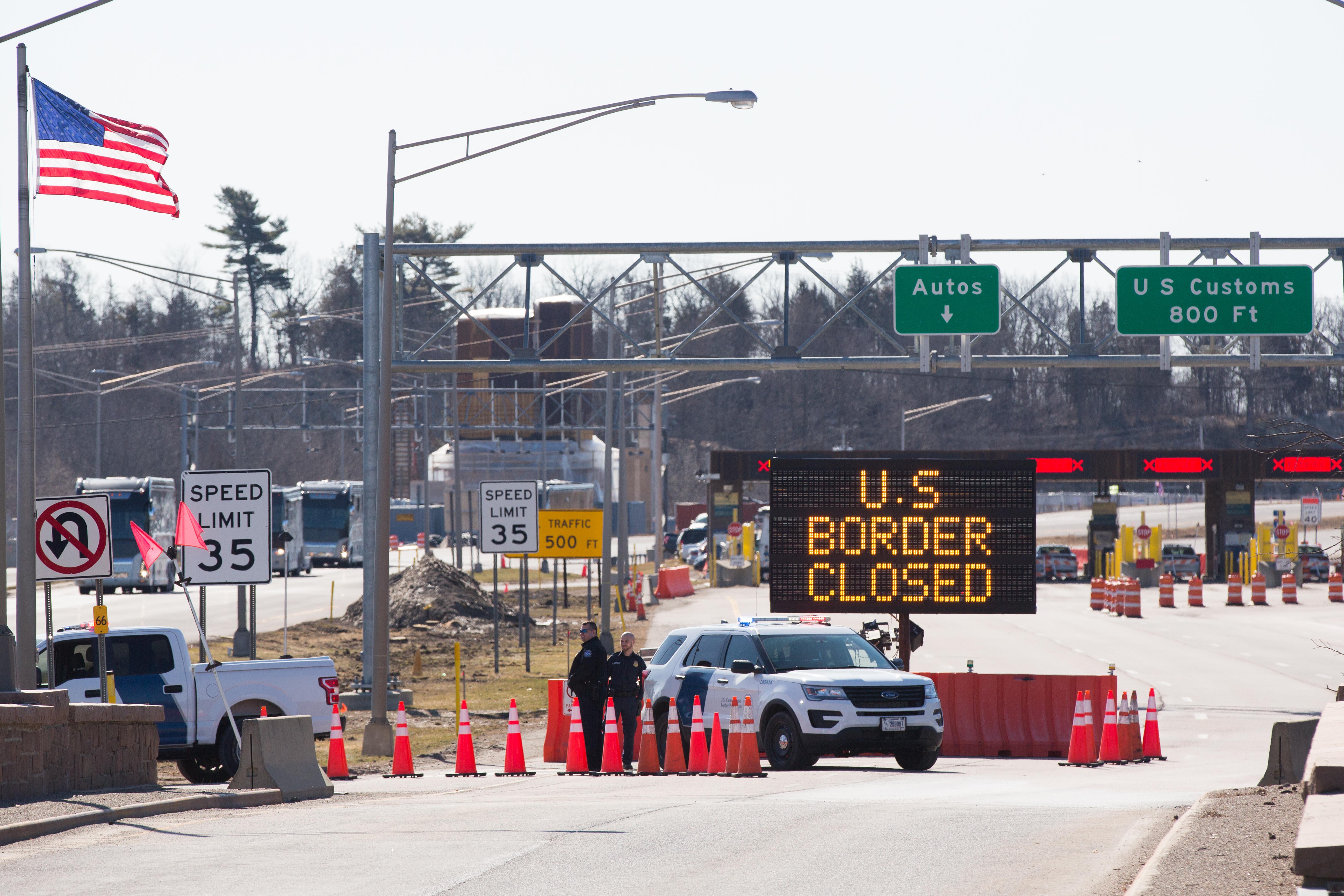 A sign reading "U.S. border closed" in front of a checkpoint.