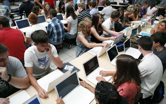 Students set up their donated laptop computers on the first day of school at Joplin High School in Joplin, Missouri.