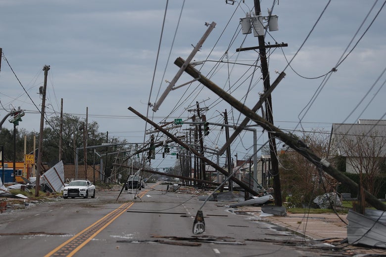 Damaged phone lines are seen along a street.