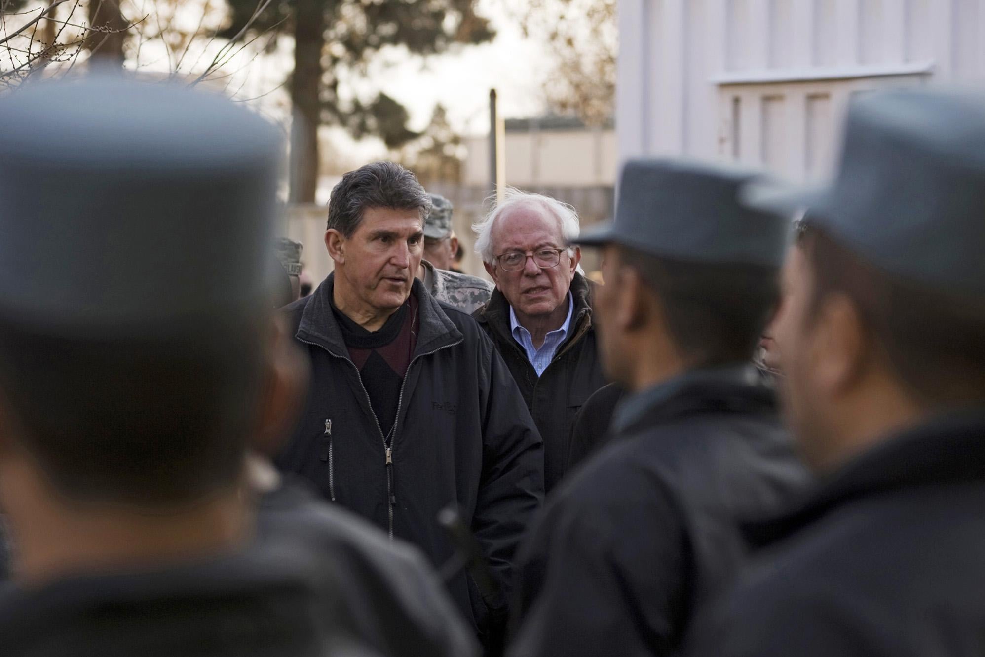 Sen. Joe Manchin and Sen. Bernie Sanders look over cadets at the Afghan National Police Academy on February 20, 2011 in Kabul, Afghanistan.  