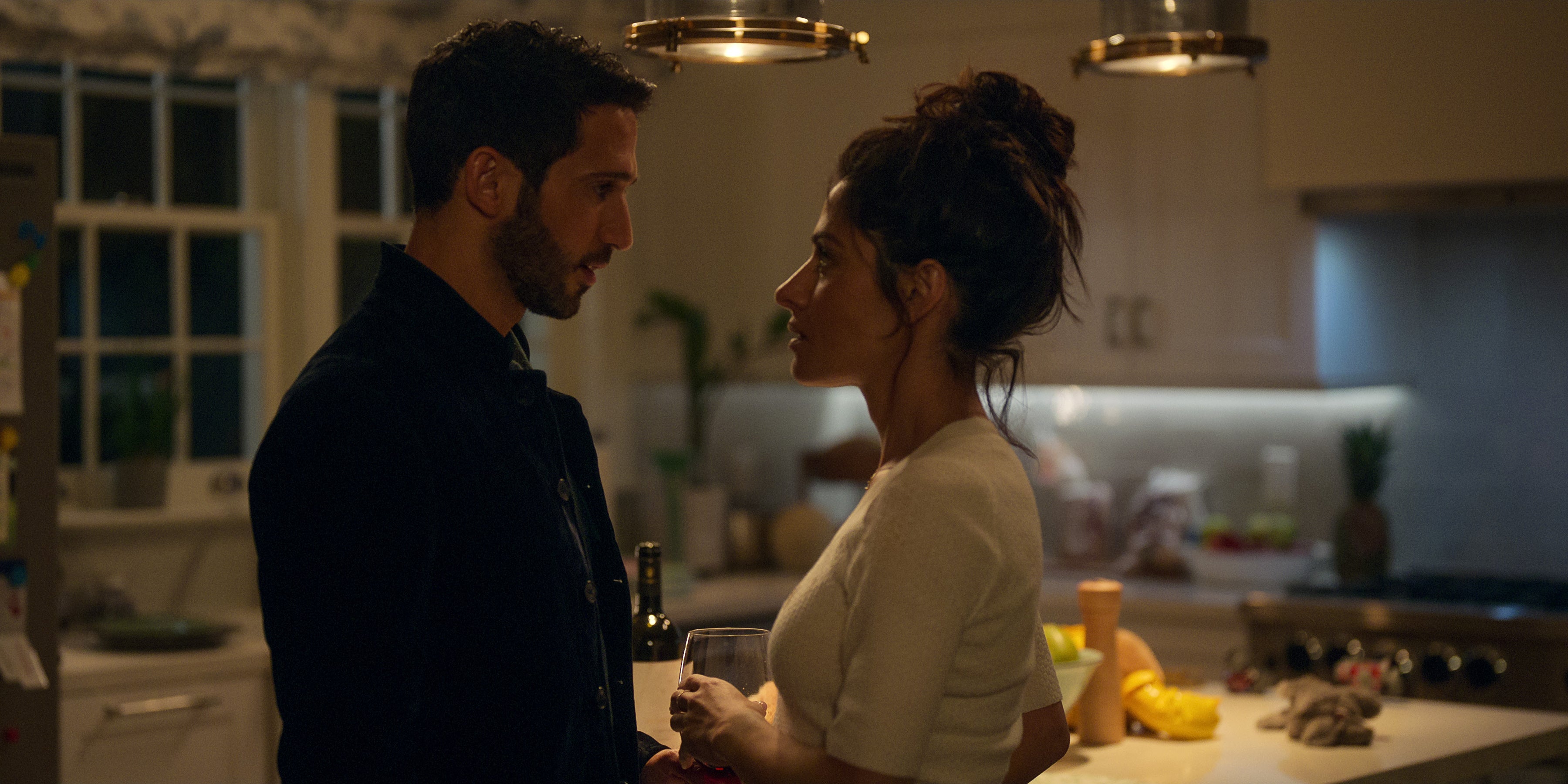 A man and a woman in a kitchen.