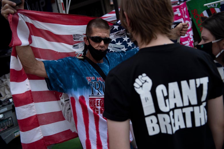 A Trump supporter and Black Lives Matter protester talk before a rally with US President Donald Trump later at the BOK Center on June 20, 2020, in Tulsa, Oklahoma.
