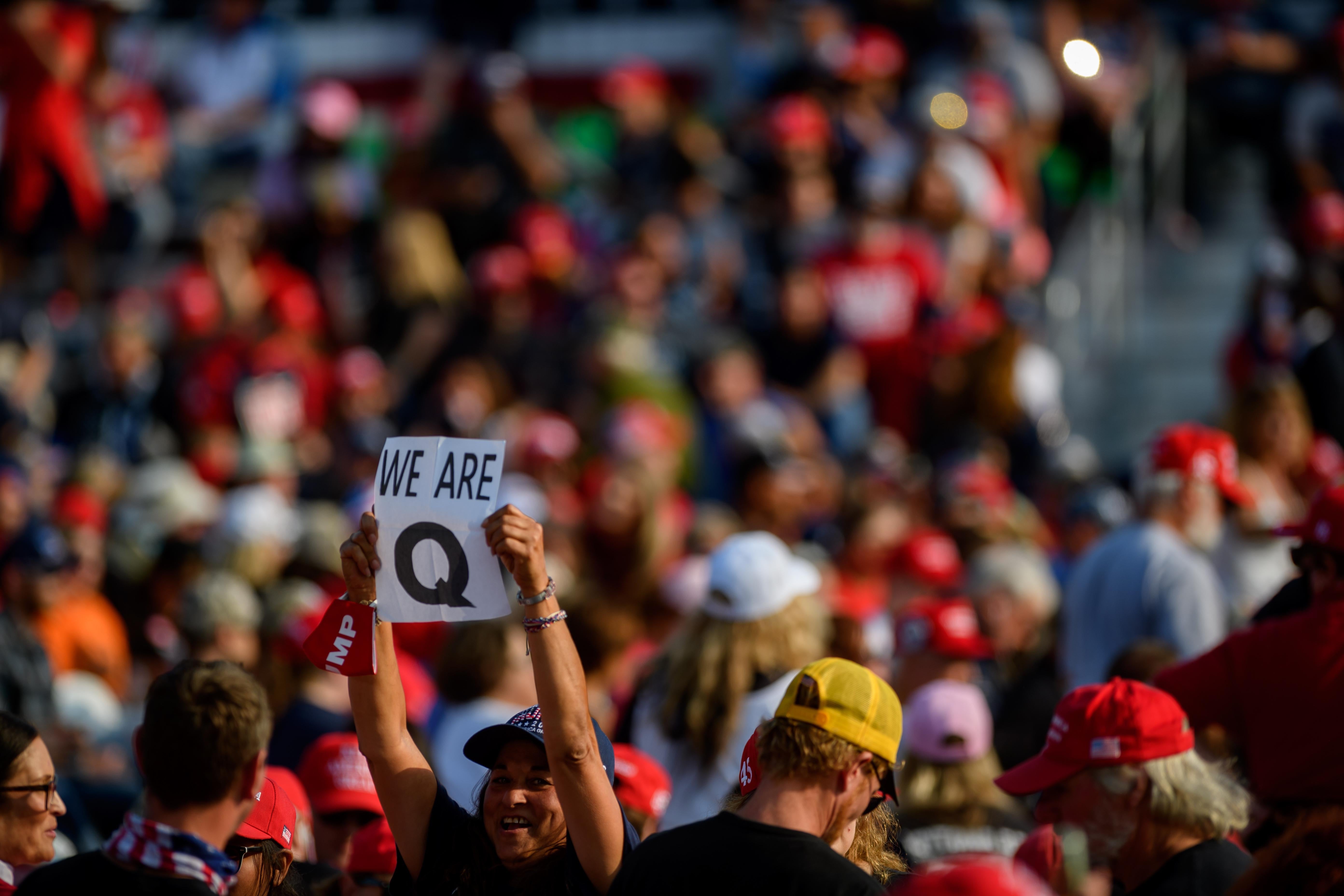 A person holds up a QAnon sign amid the crowd at a Trump rally on Sept. 22.