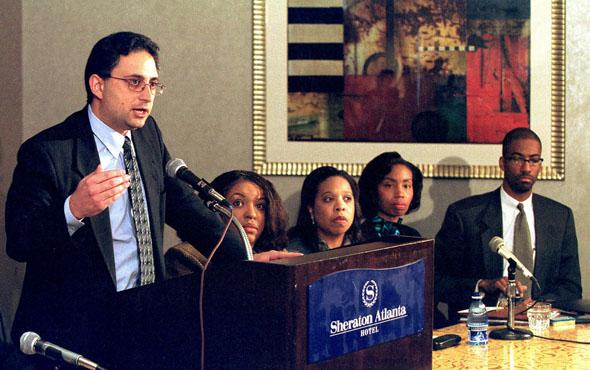 Lead defense attorney Cyrus Mehri (L) talks at a press conference announcing the racial discrimination settlement with Coca-Cola in Atlanta, 16 November 2000. 
