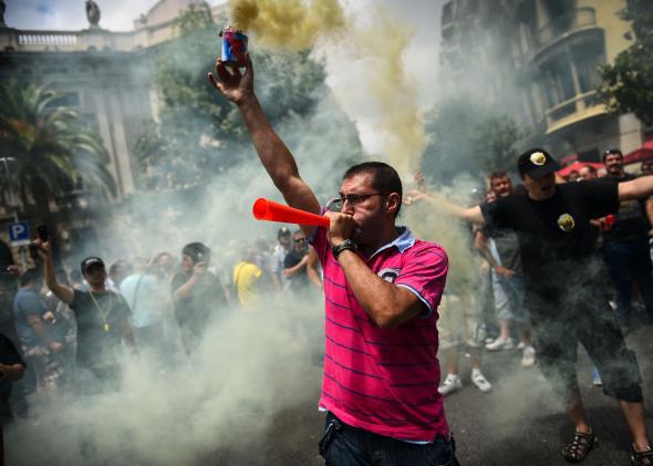 Taxi drivers protest against a new smart phones app 'Uber' during a 24 hours strike on July 1, 2014 in Barcelona, Spain.