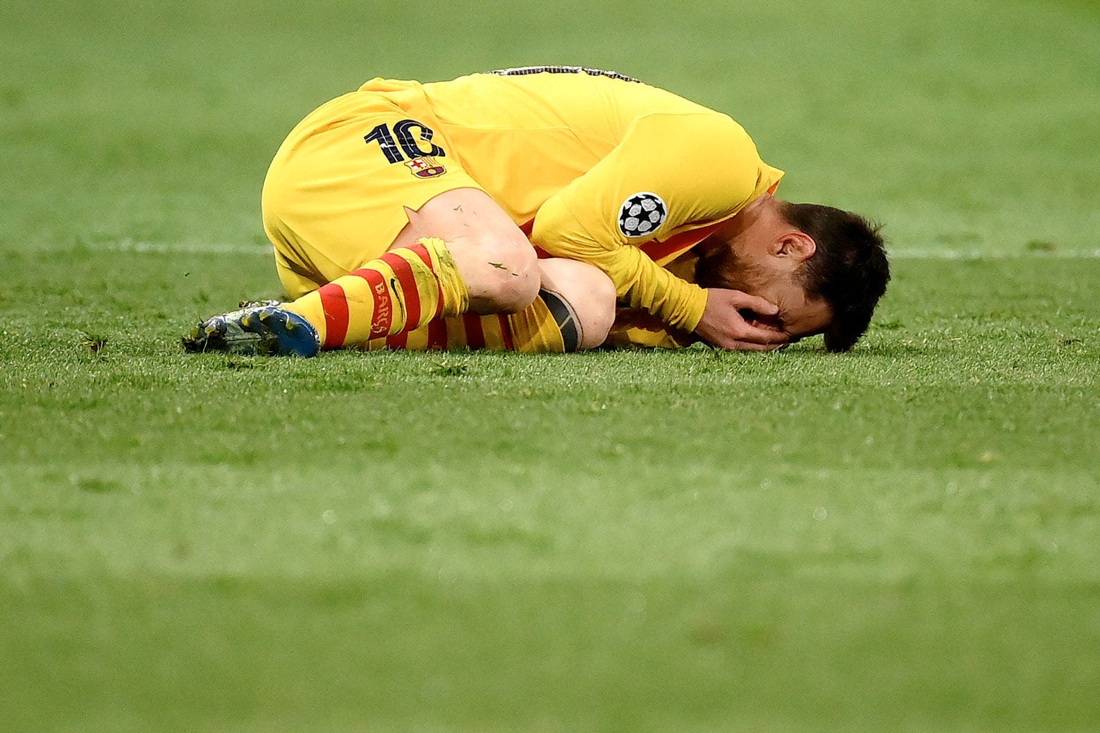 Messi curled up on the pitch with his face in his hands crying