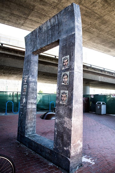 Sculpture with posters of John Cowell’s picture being crossed out.