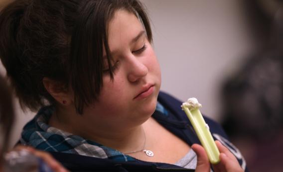 Karley Workman, 14, examines a healthy snack during the Shapedown program