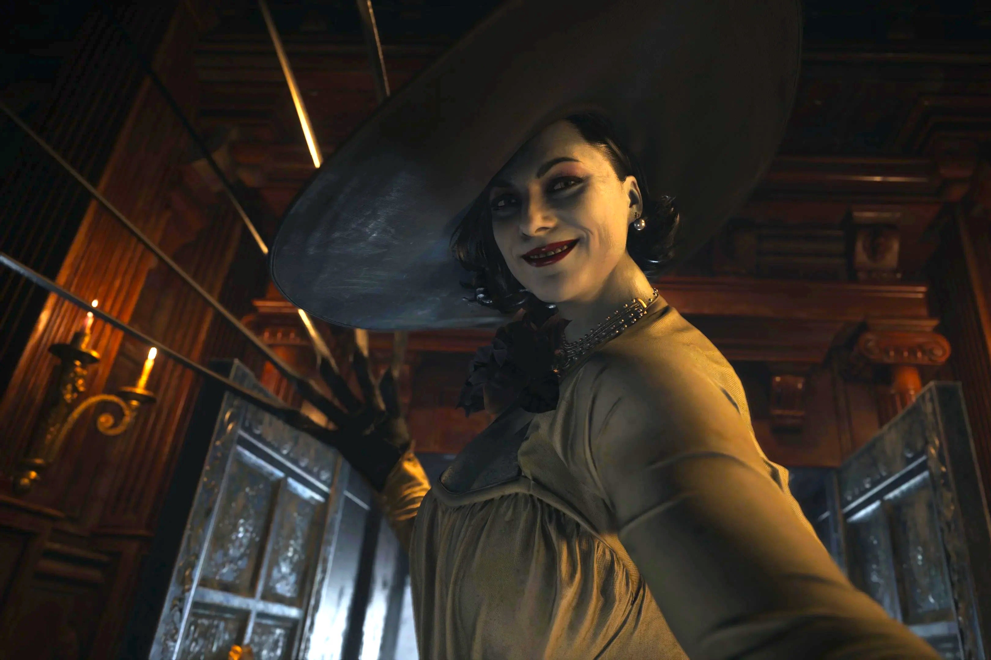 A woman with a big white hat, black hair, red lips, and pale white skin bares her claws as she eyes and smiles at the camera. 