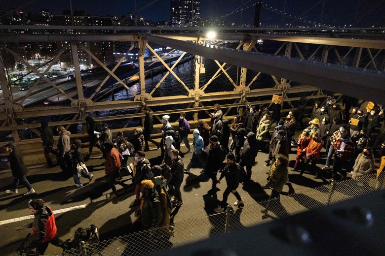 Demonstrators march on the Brooklyn Bridge during a protest against the Kyle Rittenhouse not-guilty verdict near the Barclays Center in New York on November 19, 2021. 