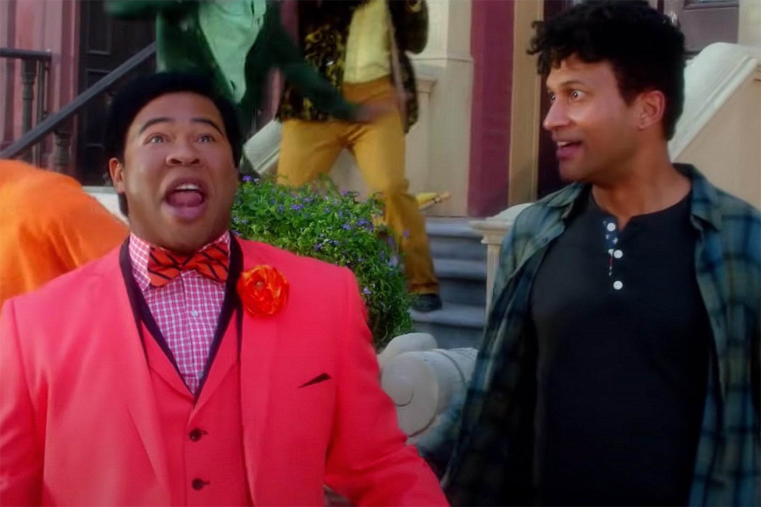 Keegan-Michael Key, in contemporary clothes, stares in awe at a Technicolor-suited Jordan Peele, who is singing.