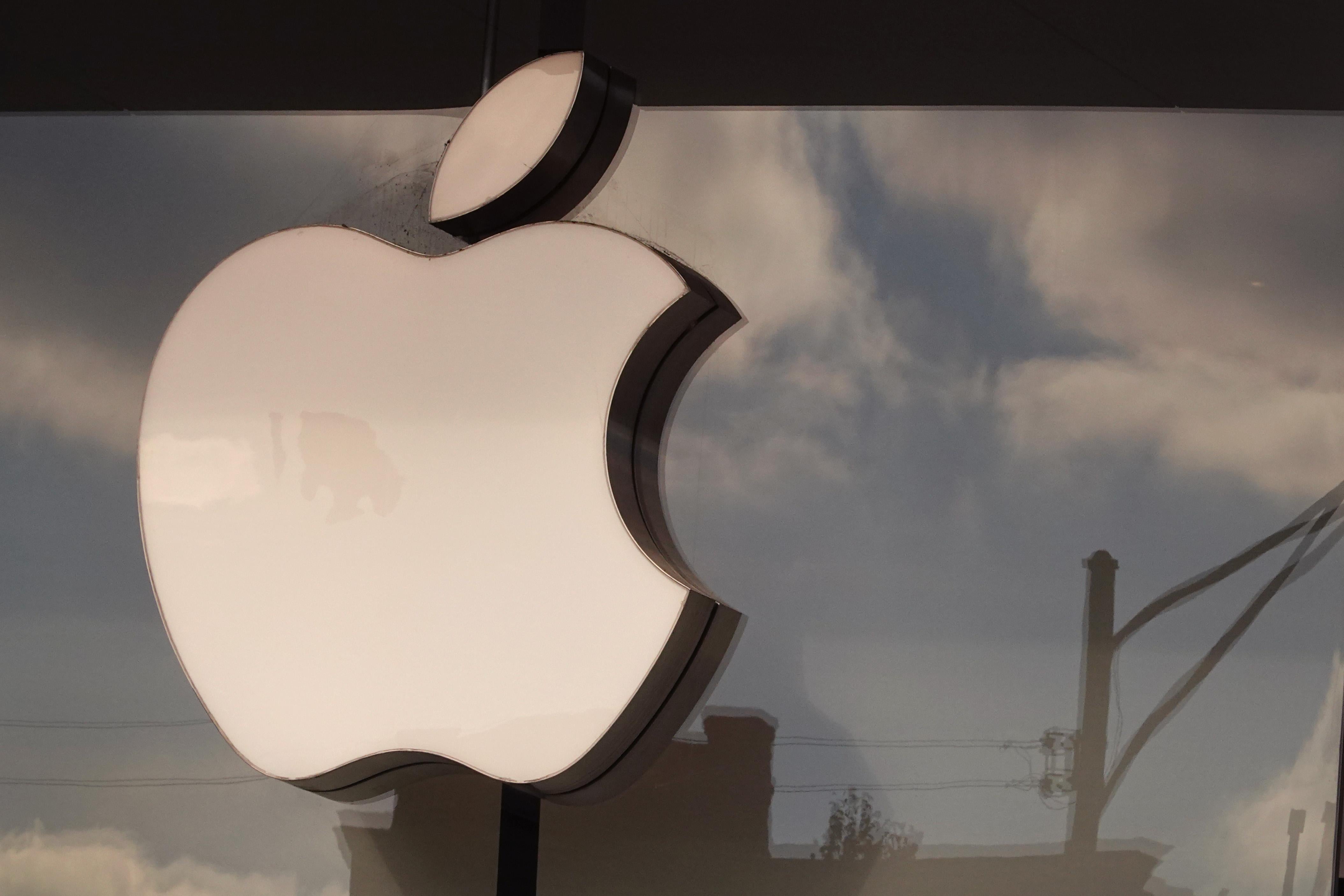 CHICAGO, ILLINOIS - NOVEMBER 28: The Apple company logo hangs above an Apple retail store on November 28, 2022 in Chicago, Illinois. Apple is currently facing shortages in iPhone supplies due to COVID-19 restrictions in China and unrest at one of Apple's major Chinese suppliers.  (Photo by Scott Olson/Getty Images)