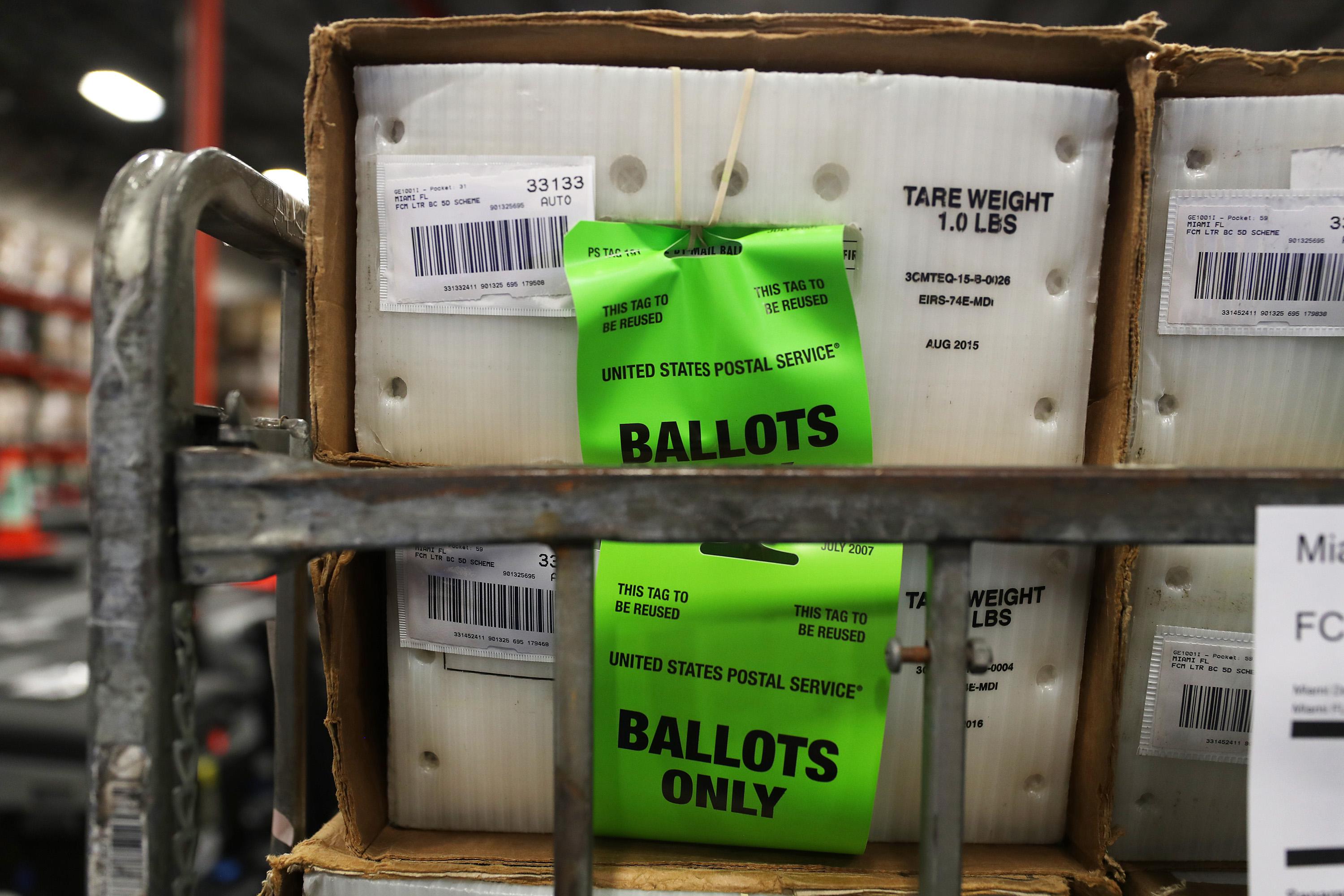 Boxes of ballots stacked on a cart before delivery