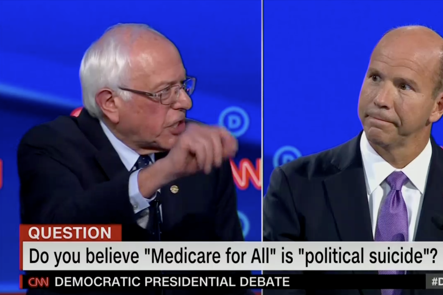 In this screengrab from CNN, Bernie Sanders and Tom Delaney argue. The banner reads: “Do you believe ‘Medicare for All’ is ‘political suicide’ ?”
