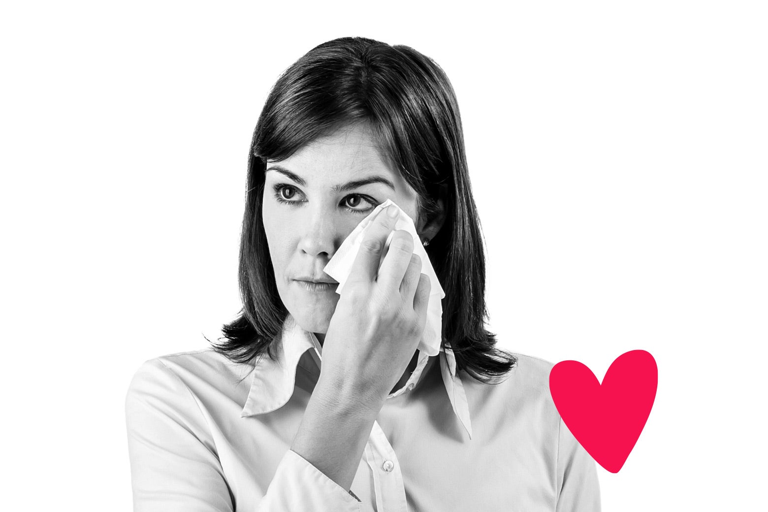 A woman dabs her eyes with a tissue, with an illo heart on her sleeve.