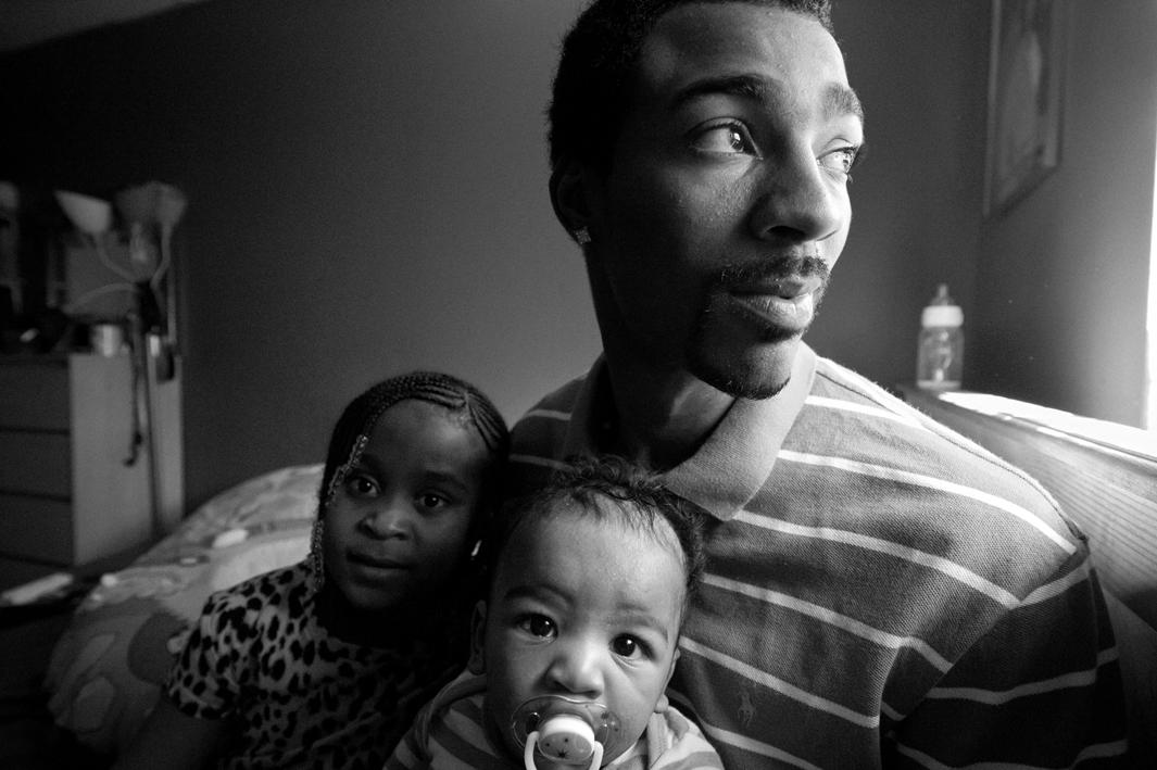  Bronx, New York, 2011. Guy Miller gets ready for an afternoon nap with daughter Nijeyah and son Guy Jr.