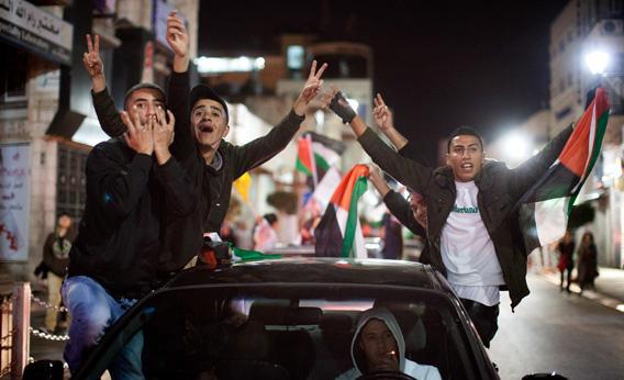 Palestinians in Ramallah, the West Bank celebrate the UN General Assembly's decision.