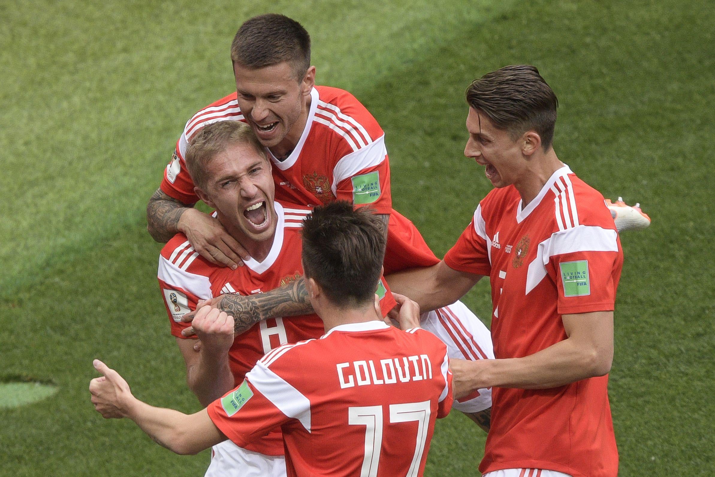 TOPSHOT - Russia's midfielder Yuri Gazinskiy (centre L) celebrates his goal with teammates during the Russia 2018 World Cup Group A football match between Russia and Saudi Arabia at the Luzhniki Stadium in Moscow on June 14, 2018. (Photo by Juan Mabromata / AFP) / RESTRICTED TO EDITORIAL USE - NO MOBILE PUSH ALERTS/DOWNLOADS        (Photo credit should read JUAN MABROMATA/AFP/Getty Images)