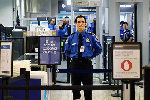 A TSA agent waits for passengers to use the TSA PreCheck lane being implemented by the Transportation Security Administration at Miami International Airport on October 4, 2011 in Miami, Florida. 