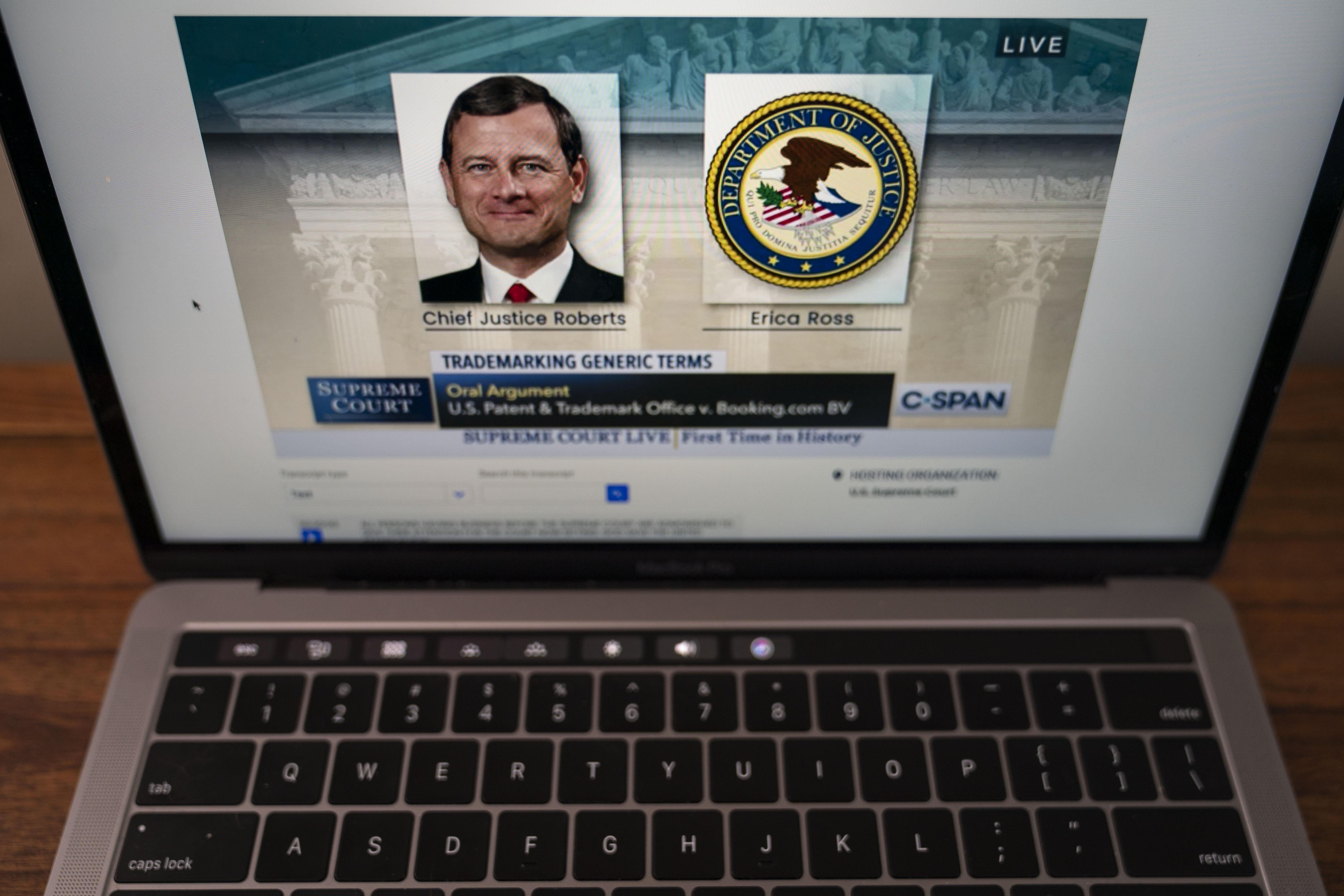 MacBook open to the Supreme Court livestream with John Roberts' photo on the screen as he speaks