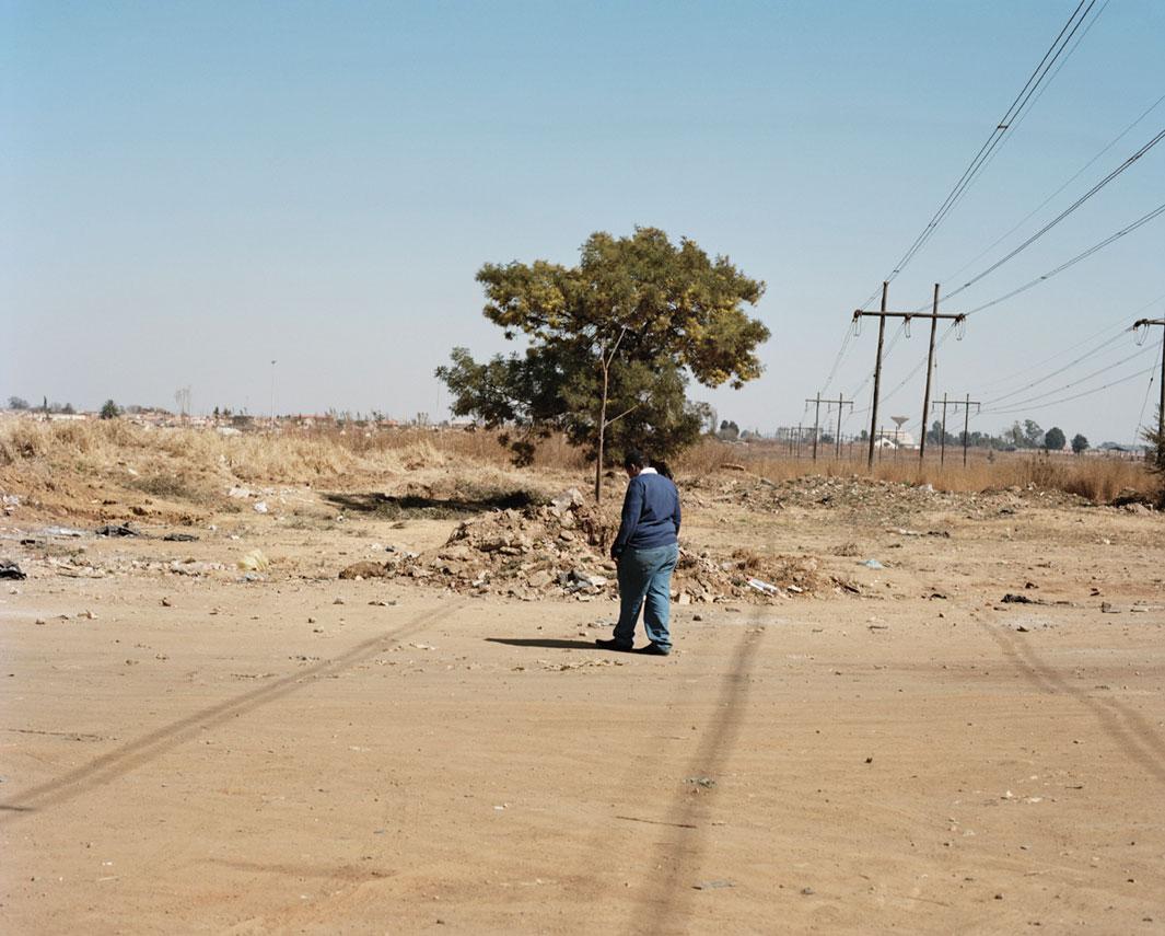 Lungile Dla Dla, Daveyton, Johannesburg Lungile stands in a field were she and a friend were raped by gunpoint in February 2010.  "He started saying he was going to show us that we are women and we are not men. He undressed us first and then tied our hands and feet. I remember thinking, please not again, because my dad had raped me when I was seven.”** Lungile is photographed at the scene of the crime. 