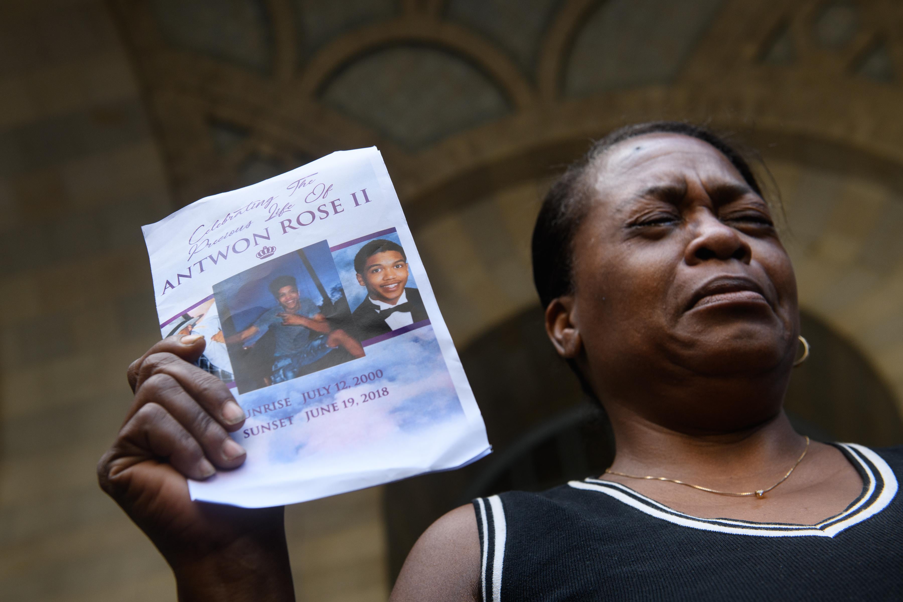 Carmen Ashley, Antwon Rose's great aunt, cries as she holds the memorial card from Rose's funeral during a protest.